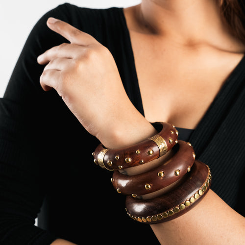 Three wooden bangles with rows of brass studs