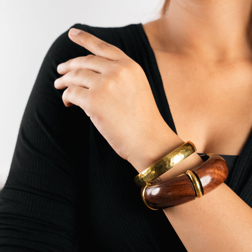 Set of handmade wooden bangles with golden accents