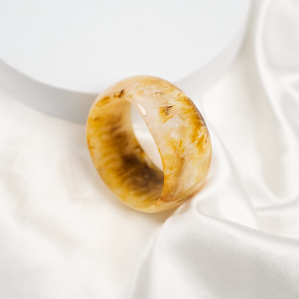 Golden Marble chunky resin bangle on a plain background