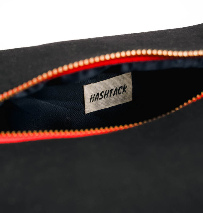 Side view of black utility pouch for women showing slim profile