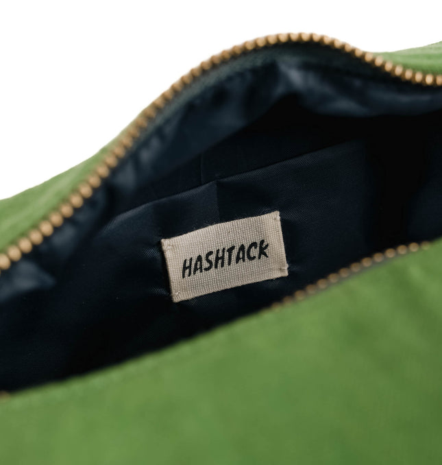 Side angle of olive green utility pouch for women showing structure