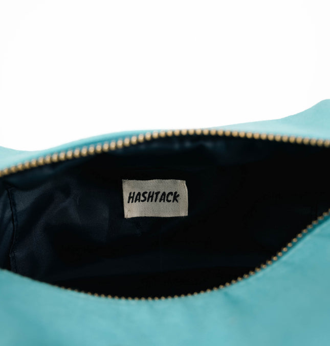 Aqua blue utility pouch for women angled view showing texture