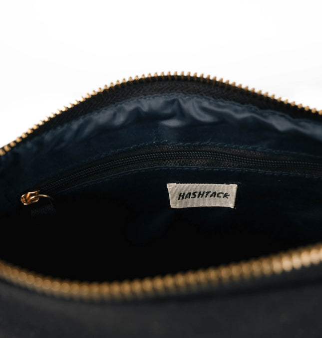 Black clutch pouch with strap for women showing detachable wristlet