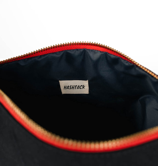Black and red wristlet pouch for women showing strap detail