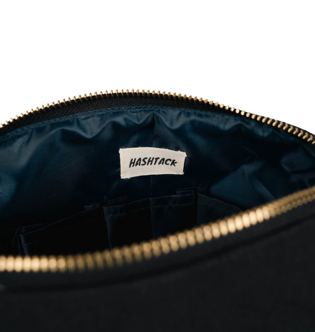 Black multi compartment utility pouch for women showing strap