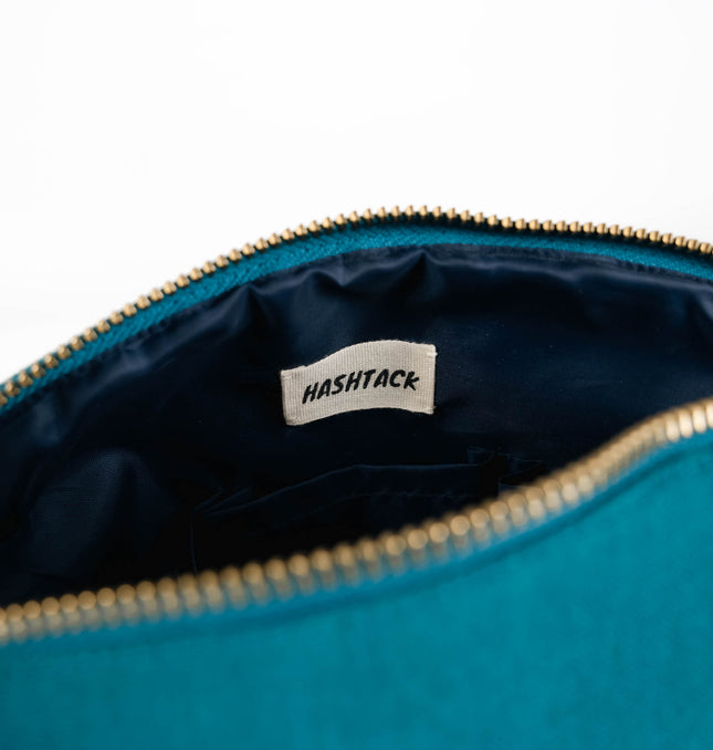 Turquoise blue utility pouch for women showing strap detail