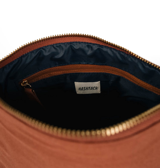 Terracotta brown utility pouch for women showing strap detail