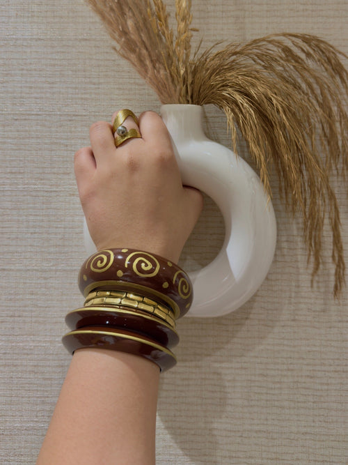Maroon and gold spiral bangle set